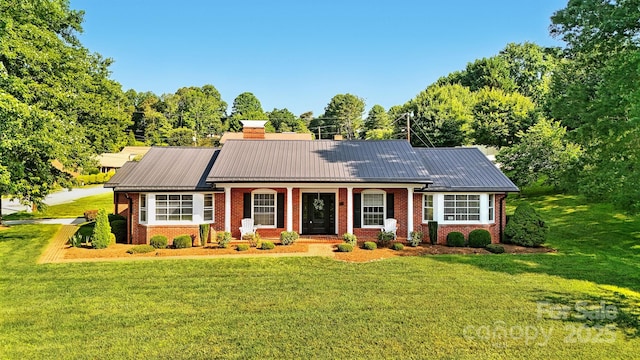 601 Pennell St NE, Lenoir, NC 28645 - single story home featuring a metal roof, a front yard, brick siding, and a chimney