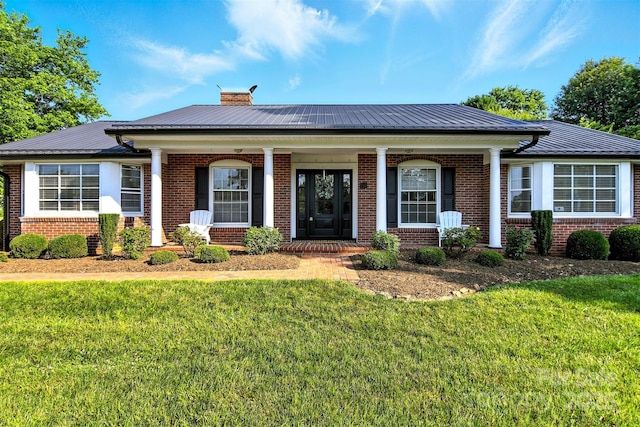 601 Pennell St NE, Lenoir, NC 28645 - view of front facade featuring brick siding, a chimney, a front lawn, and covered porch