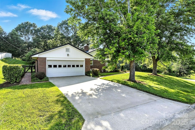 601 Pennell St NE, Lenoir, NC 28645 - view of front of property with brick siding, driveway, a front yard, and a chimney