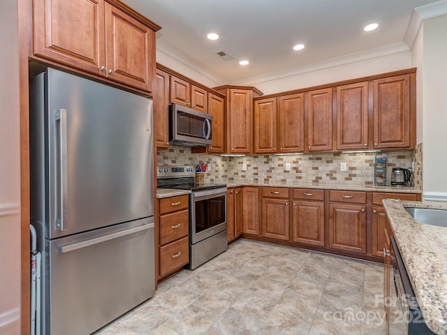 15739 Circlegreen Dr, Charlotte, NC 28273 - kitchen with appliances with stainless steel finishes, brown cabinetry, light stone counters, tasteful backsplash, and ornamental molding
