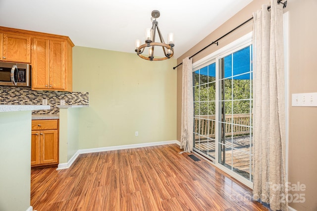 610 Mountain Pl, Albemarle, NC 28001 - unfurnished dining area featuring a chandelier and light wood-type flooring
