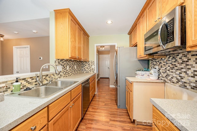 610 Mountain Pl, Albemarle, NC 28001 - kitchen with stainless steel appliances, light wood finished floors, light countertops, backsplash, and recessed lighting