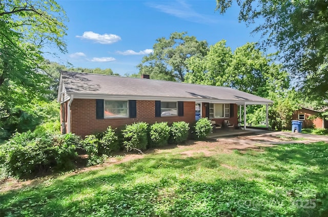 113 N Academy St, Mooresboro, NC 28114 - single story home with brick siding, a front lawn, covered porch, and an attached carport