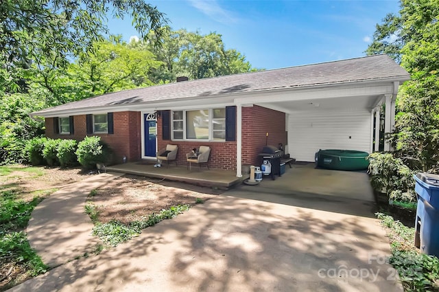 113 N Academy St, Mooresboro, NC 28114 - ranch-style house with brick siding, an attached carport, driveway, and roof with shingles
