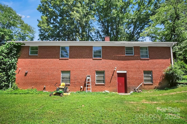 113 N Academy St, Mooresboro, NC 28114 - view of front of home featuring a chimney, a front yard, and brick siding