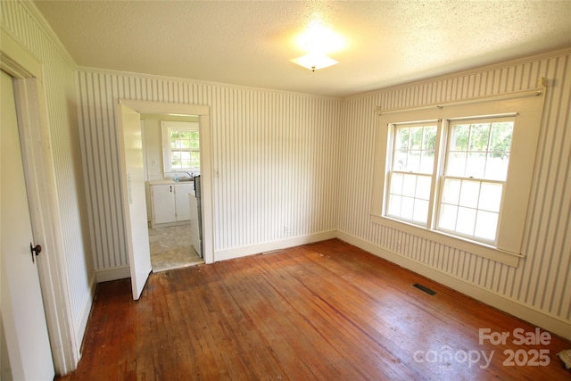 1541 Kings Rd, Shelby, NC 28150 - spare room featuring wood-type flooring, crown molding, and a textured ceiling