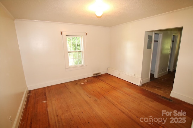 1541 Kings Rd, Shelby, NC 28150 - empty room with crown molding, hardwood / wood-style flooring, electric panel, and a textured ceiling
