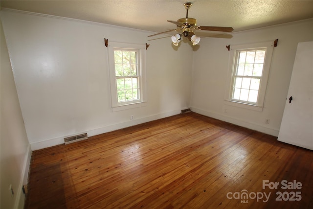 1541 Kings Rd, Shelby, NC 28150 - empty room with healthy amount of natural light, ornamental molding, hardwood / wood-style flooring, and a ceiling fan
