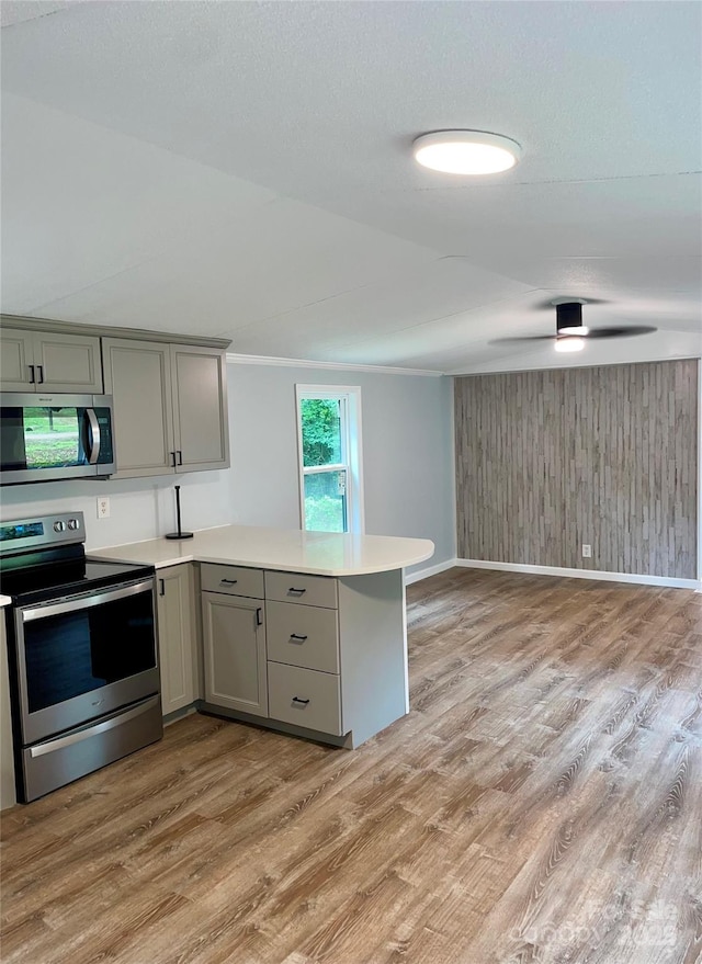 6517 Helens Way, Denver, NC 28037 - kitchen featuring appliances with stainless steel finishes, gray cabinets, light wood-style floors, and wood walls