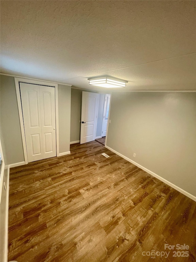 6517 Helens Way, Denver, NC 28037 - unfurnished bedroom with wood finished floors, a textured ceiling, and a closet