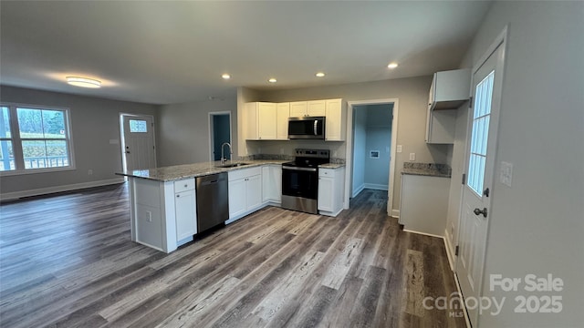 440 Brown Acres Rd, Salisbury, NC 28146 - kitchen with appliances with stainless steel finishes, a peninsula, recessed lighting, dark wood-style flooring, and white cabinets