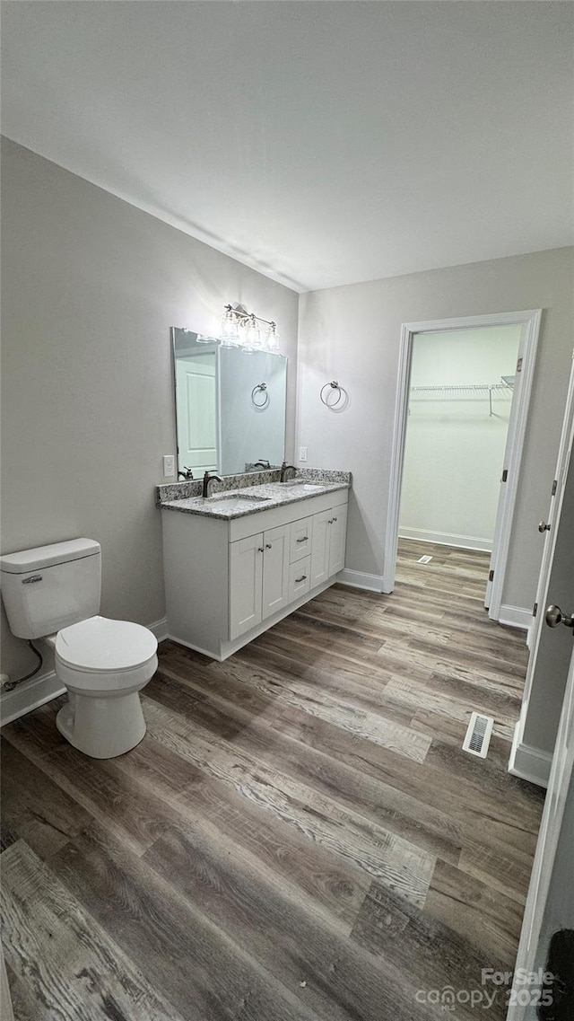 440 Brown Acres Rd, Salisbury, NC 28146 - bathroom featuring wood finished floors, double vanity, and a spacious closet