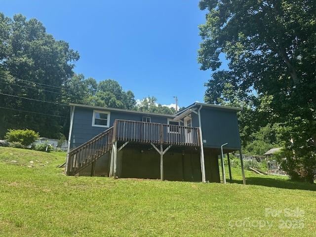 1011 Warren Pl NW, Lenoir, NC 28645 - back of property with a deck, a lawn, and stairs