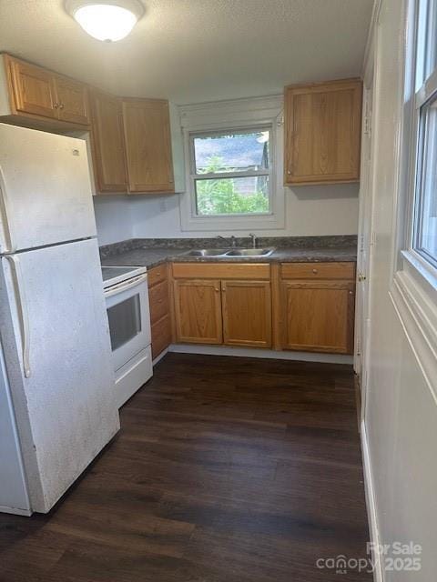 1011 Warren Pl NW, Lenoir, NC 28645 - kitchen with white appliances, dark wood-style flooring, and dark countertops