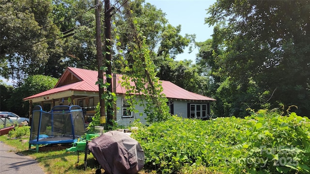 160 Cleveland Rd, Tryon, NC 28782 - view of property exterior featuring a trampoline and a metal roof