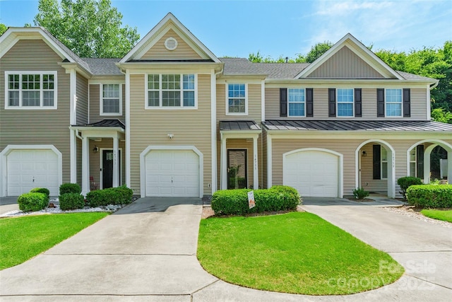 14755 Lions Paw St, Charlotte, NC 28273 - multi unit property featuring a standing seam roof, concrete driveway, a front yard, and a garage