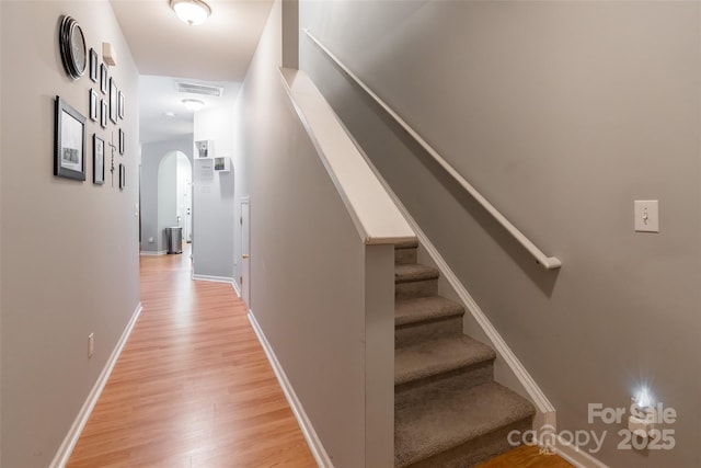 14755 Lions Paw St, Charlotte, NC 28273 - hallway with light wood-style floors, stairway, and arched walkways