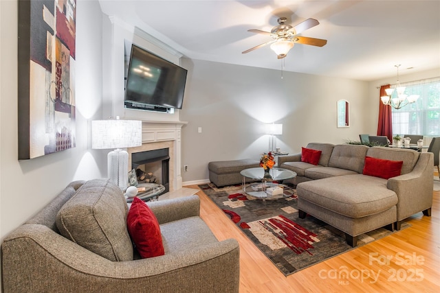 14755 Lions Paw St, Charlotte, NC 28273 - living area with a chandelier, wood finished floors, ceiling fan, and a fireplace