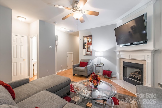 14755 Lions Paw St, Charlotte, NC 28273 - living area featuring wood finished floors, a ceiling fan, and a premium fireplace