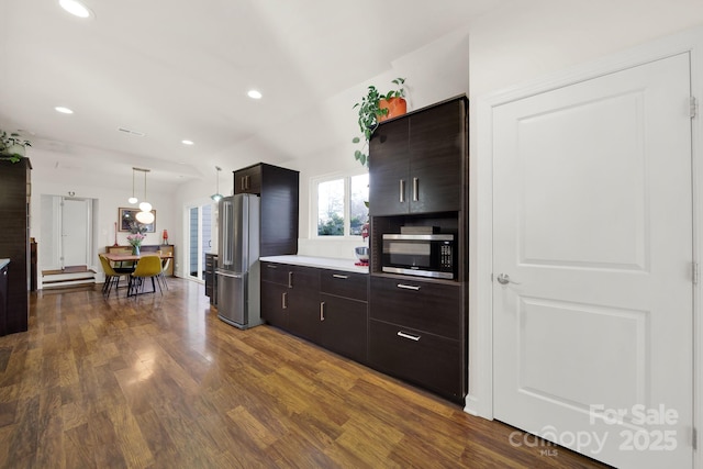 2314 Wolfe St, Charlotte, NC 28205 - kitchen with appliances with stainless steel finishes, dark wood finished floors, light countertops, dark brown cabinetry, and recessed lighting