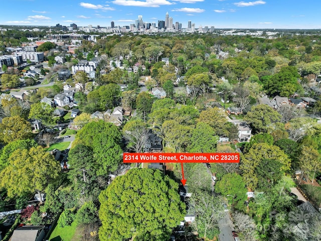2314 Wolfe St, Charlotte, NC 28205 - aerial overview of property's location featuring skyline and a tree filled landscape