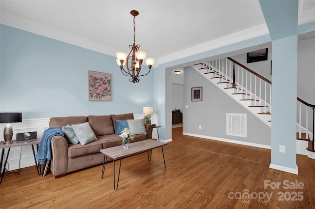 10104 Treetop Ln, Cornelius, NC 28031 - living room featuring stairs, wood finished floors, and a chandelier