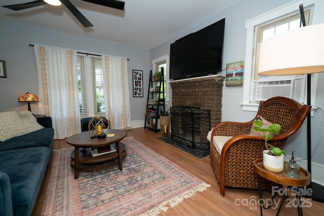 1712 Umstead St, Charlotte, NC 28205 - living area with wood finished floors, ceiling fan, cooling unit, and a fireplace