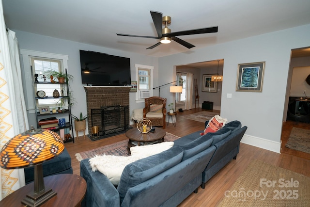 1712 Umstead St, Charlotte, NC 28205 - living room with a fireplace, ceiling fan, and wood finished floors