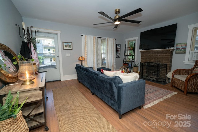 1712 Umstead St, Charlotte, NC 28205 - living room featuring a fireplace, ceiling fan, and wood finished floors