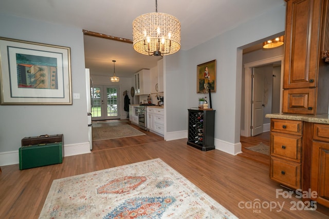 1712 Umstead St, Charlotte, NC 28205 - dining space featuring wood finished floors, a chandelier, and french doors