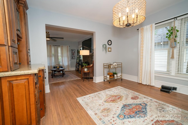 1712 Umstead St, Charlotte, NC 28205 - living area with a chandelier, plenty of natural light, light wood-style flooring, and a ceiling fan