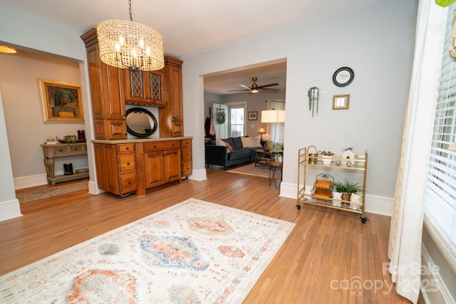 1712 Umstead St, Charlotte, NC 28205 - entrance foyer featuring light wood-type flooring, a chandelier, and ceiling fan