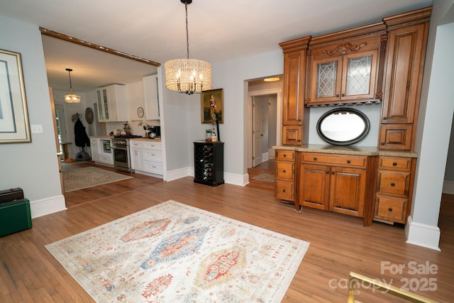 1712 Umstead St, Charlotte, NC 28205 - dining room with a chandelier and light wood-style flooring