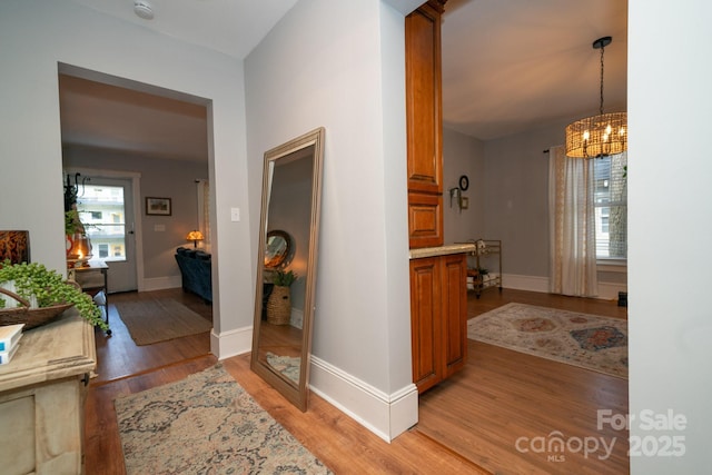 1712 Umstead St, Charlotte, NC 28205 - hall with light wood-type flooring and a chandelier