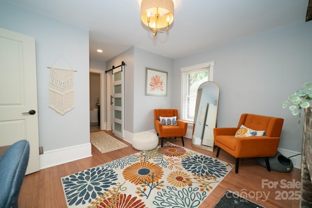 1712 Umstead St, Charlotte, NC 28205 - living area with a barn door, wood finished floors, and recessed lighting