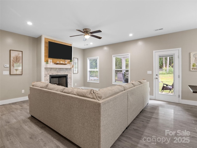 226 Oak Brook Ln Unit 21, Gaffney, SC 29341 - living room with wood finished floors, ceiling fan, a stone fireplace, and recessed lighting