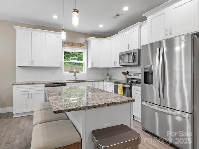 226 Oak Brook Ln Unit 21, Gaffney, SC 29341 - kitchen with appliances with stainless steel finishes, light wood-style flooring, white cabinets, backsplash, and recessed lighting