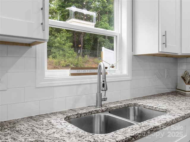 226 Oak Brook Ln Unit 21, Gaffney, SC 29341 - kitchen featuring backsplash, white cabinetry, light stone countertops, and healthy amount of natural light