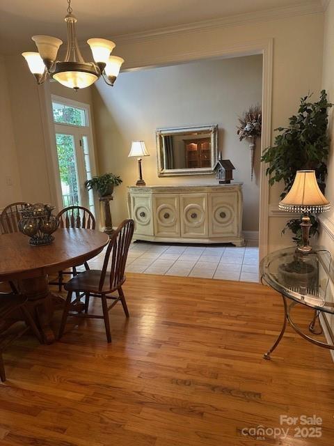 104 Whimbrel Ln, Mooresville, NC 28117 - dining area with crown molding, light wood-type flooring, and a chandelier