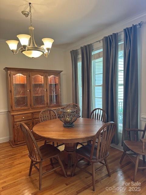 104 Whimbrel Ln, Mooresville, NC 28117 - dining area featuring light wood finished floors, a chandelier, and crown molding