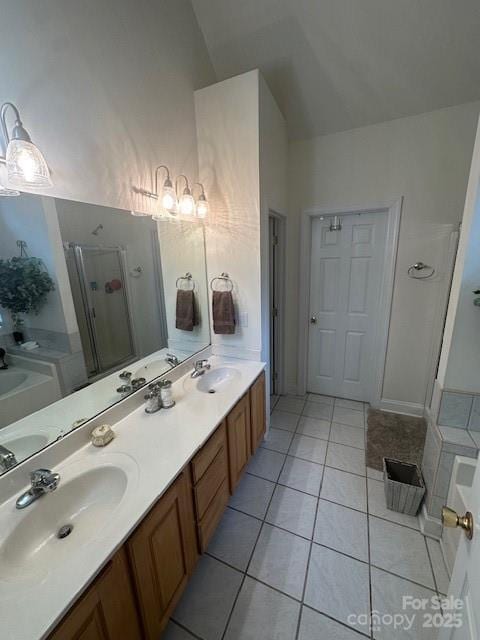 104 Whimbrel Ln, Mooresville, NC 28117 - bathroom with a shower stall, tile patterned floors, a bath, double vanity, and lofted ceiling