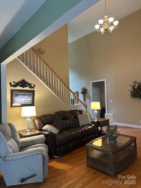 104 Whimbrel Ln, Mooresville, NC 28117 - living area with a chandelier, wood finished floors, stairway, and a towering ceiling