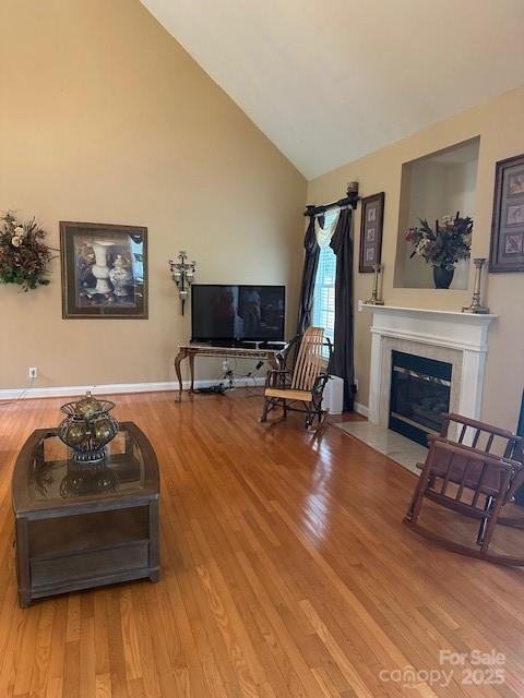 104 Whimbrel Ln, Mooresville, NC 28117 - living room featuring high vaulted ceiling, wood finished floors, and a fireplace with flush hearth