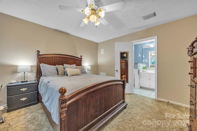 116 Eastwood Park Dr SE, Lenoir, NC 28645 - bedroom with light colored carpet, ensuite bath, ceiling fan, and a textured ceiling