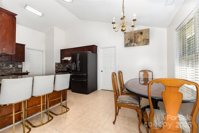 2916 Northwood Dr, Monroe, NC 28110 - dining area featuring light tile patterned floors, a chandelier, and high vaulted ceiling
