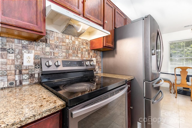 2916 Northwood Dr, Monroe, NC 28110 - kitchen featuring appliances with stainless steel finishes, under cabinet range hood, tasteful backsplash, and light stone counters