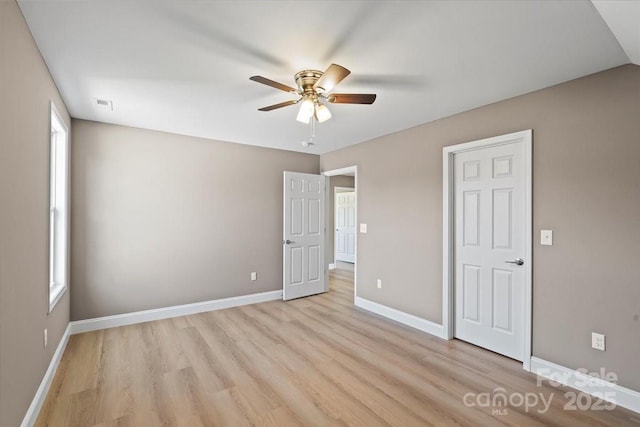 1033 12th Avenue Dr NW, Hickory, NC 28601 - unfurnished bedroom with light wood-style floors and ceiling fan