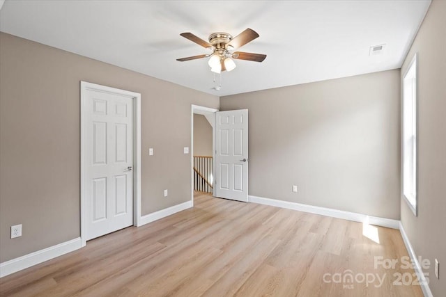 1033 12th Avenue Dr NW, Hickory, NC 28601 - unfurnished bedroom featuring light wood-style flooring and ceiling fan