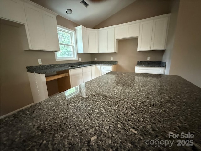 105 Elk Creek Ln, Hudson, NC 28638 - kitchen with dark stone counters, lofted ceiling, and white cabinets