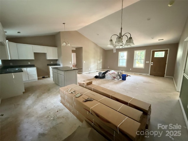105 Elk Creek Ln, Hudson, NC 28638 - kitchen featuring a chandelier, a center island, vaulted ceiling, white cabinetry, and pendant lighting